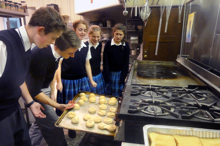 Students assist in the kitchen for the Fatima Conference banquet.